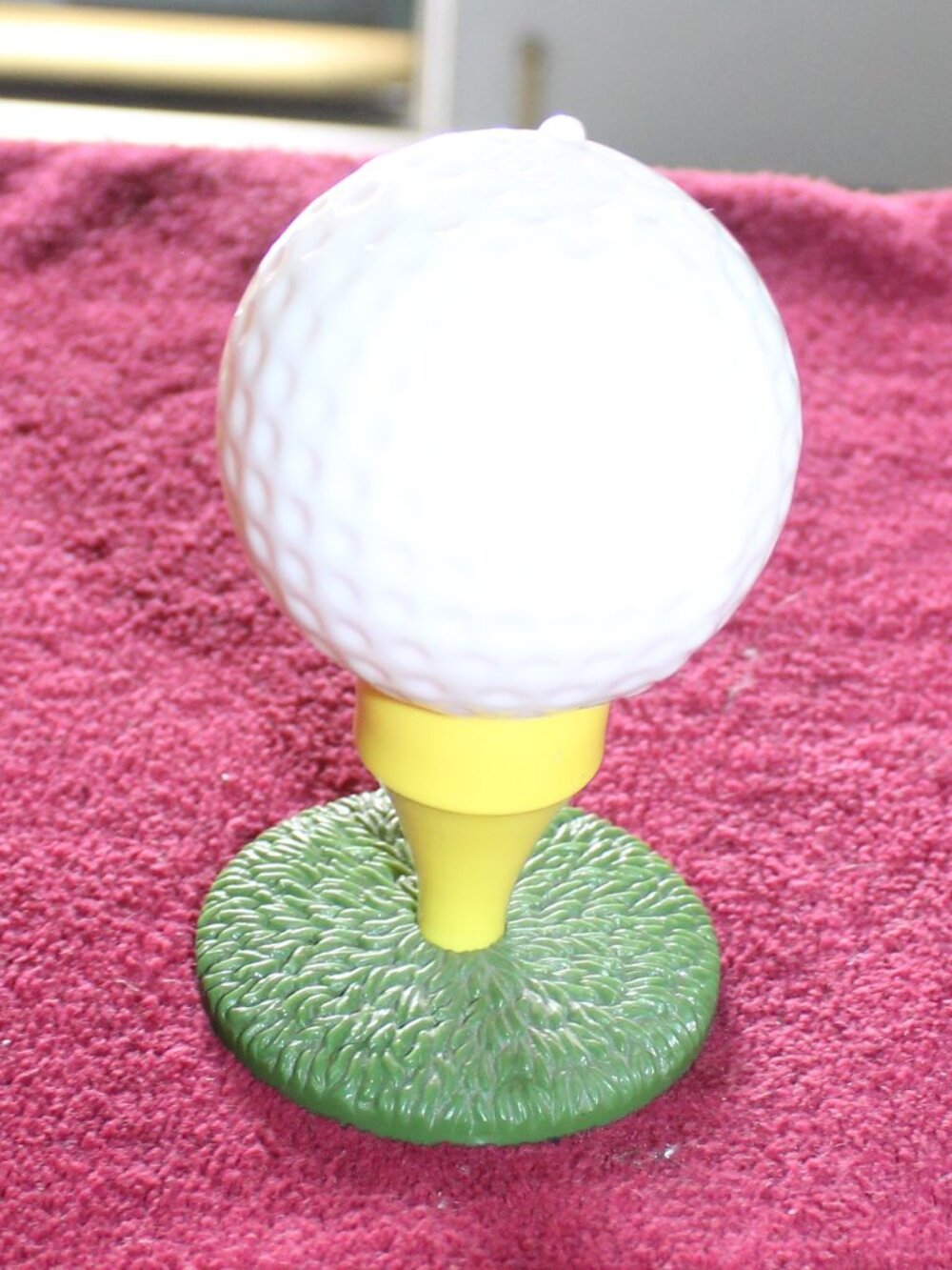 Vintage 1970s Avon "Tee-Off" decanter bottle shaped like a golf ball on a tee.